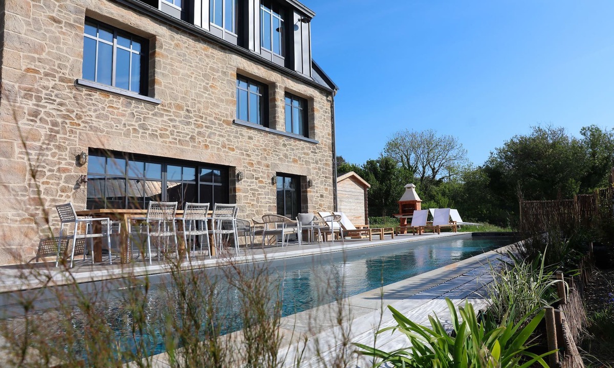 Esquibien House | Architect-designed stone house with heated pool, just ten steps from the beach