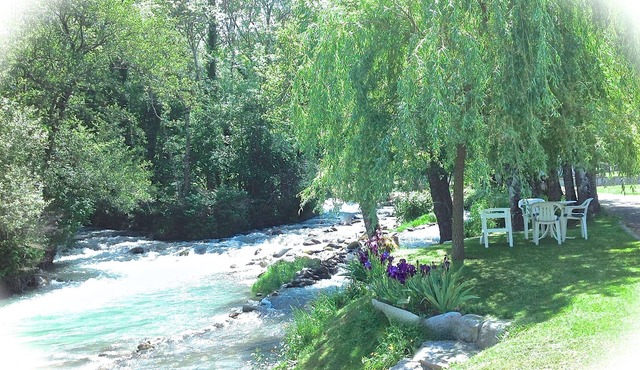 A mountain house nestling on the banks of a river *