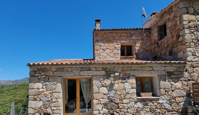 Stone house located between sea and mountains